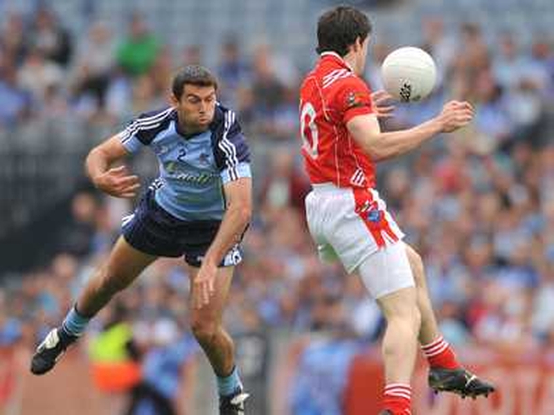 Dublin's David Henry and Louth's Adrian Reid contest the ball