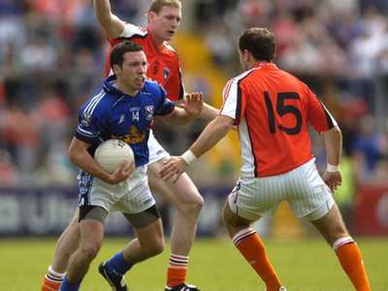 Cavan's Ronan Flanagan is challenged by Armagh's Keiran Toner and Paddy McKeever