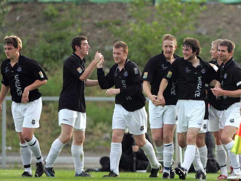 Wexford players celebrate Johnny Flynn O'Connor's opening goal at Belfield