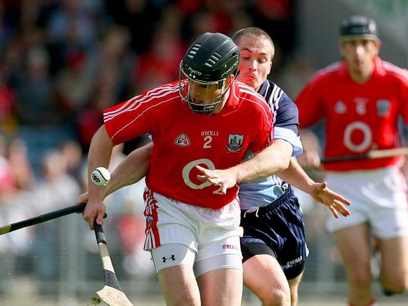 Shane O'Neill of Cork bursts past and David O'Callaghan of Dublin