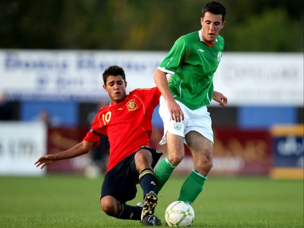 Ireland's Danny Kelly is tackled by Yago Falque of Spain