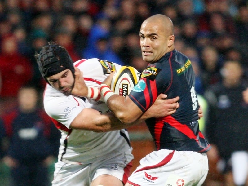 Matt McCullough of Ulster gets handed off by Sililo Martens of Llanelli