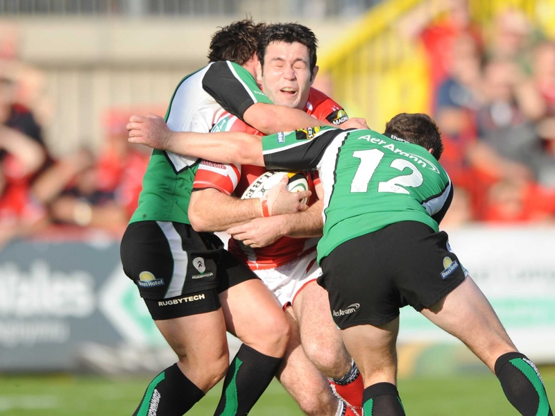 Stephen Jones is tackled by Connacht's Ian Keatley (l) and Keith Matthews (r)
