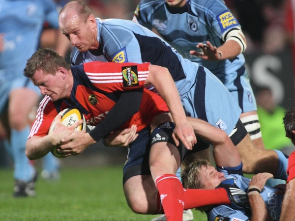 Munster's Denis Hurley is tackled by Cardiff's Gareth Thomas