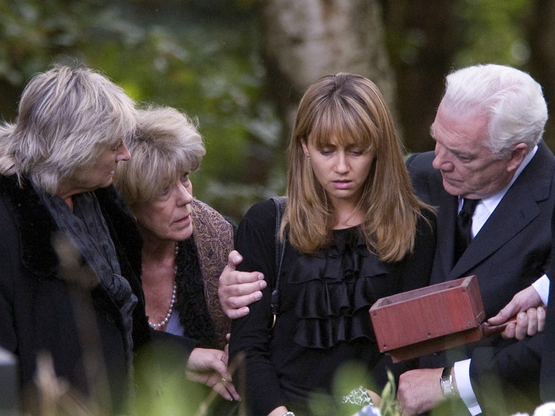 Maria is comforted by friends and family