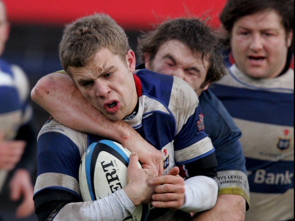 Blackrock's Ian Madigan launches an attack as former Irish international Shane Byrne looks on