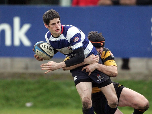 Alan Henry of Blackrock is tackled by Young Munster's Clem Casey
