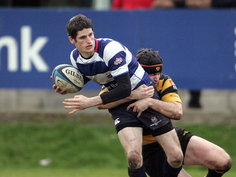 Alan Henry of Blackrock is tackled by Young Munster's Clem Casey