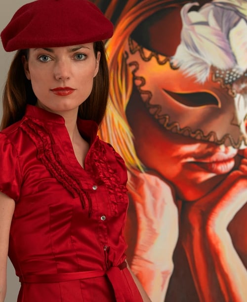 Chara Nagle photographed beside one of her dramatic paintings.