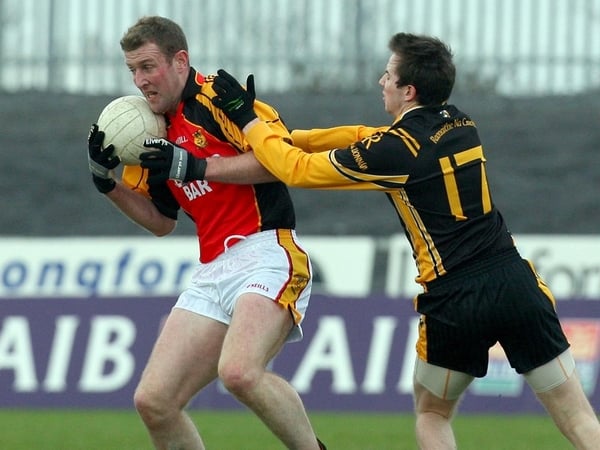 Dromcollogher's Neil Conway with two-goal Tony Kernan of Crossmaglen