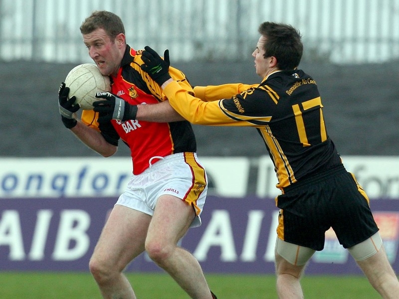 Dromcollogher's Neil Conway with two-goal Tony Kernan of Crossmaglen