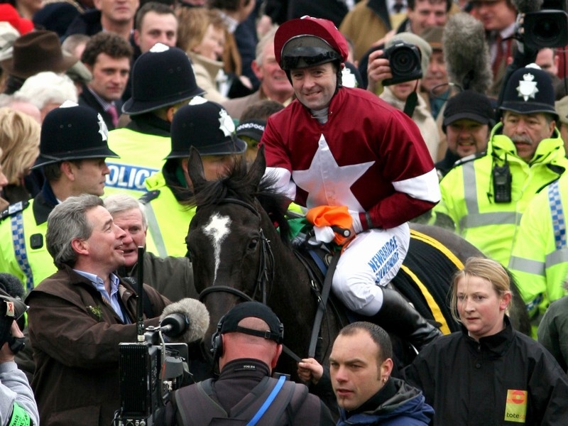 Jockey Conor O'Dwyer celebrates War Of Attrition winning the Cheltenham Gold Cup in 2006