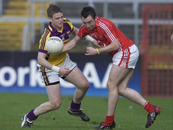 David Murphy (Wexford) and Paul Kerrigan (Cork) battle for possession by the banks of the Lee