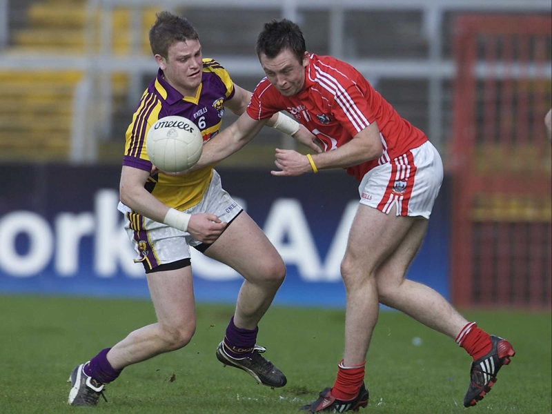 David Murphy (Wexford) and Paul Kerrigan (Cork) battle for possession by the banks of the Lee