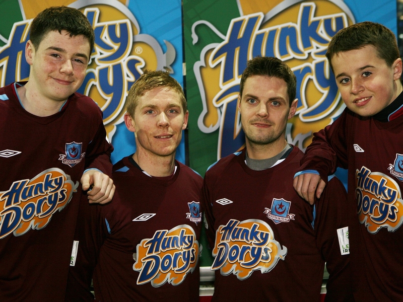 Conor Kenna, Robbie Martin and two fans pose in the new club shirt