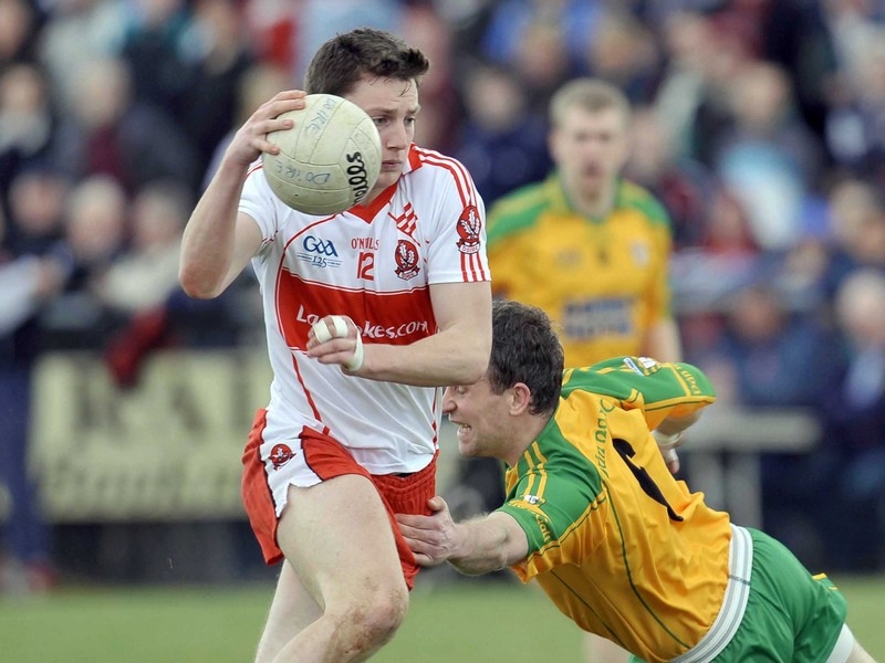 Derry's Jamie Kielt slips past the tackle of Barry Monaghan