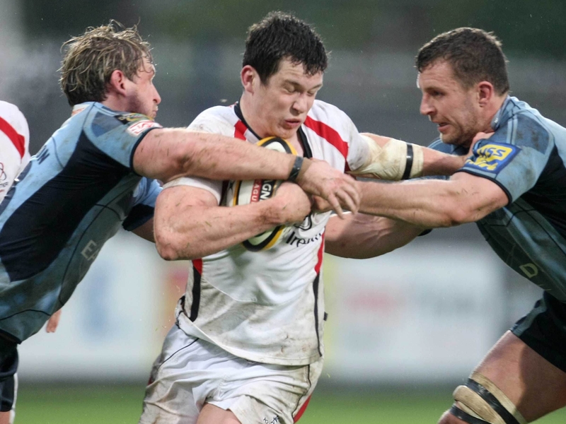 Ian Whitten is tackled by two Cardiff players