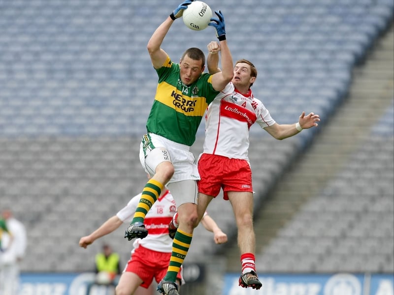 Kerry's Kieran Donaghy wins the aerial battle with Derry's Kevin McCloy at Croke Park.
