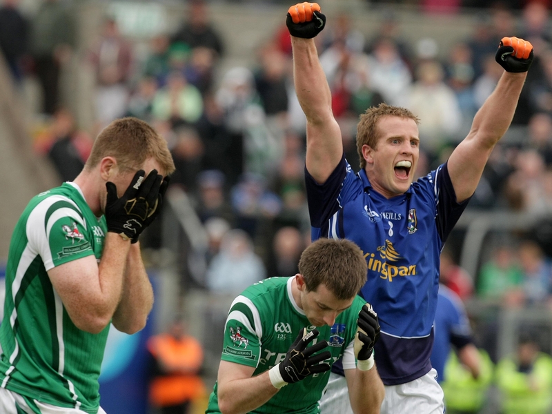 Cavan's Nicholas Walsh celebrates at the final whistle as the Fermanagh players feel the pain of defeat