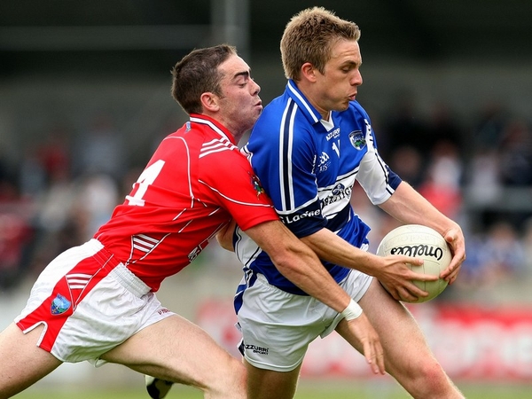 Louth's John O'Brien tries to dispossess Laois' Ross Munnelly at O'Moore Park