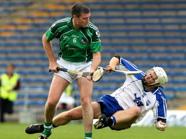 Stephen Molumphy (r) of Waterford feels the full force of Limerick's Brian Geary