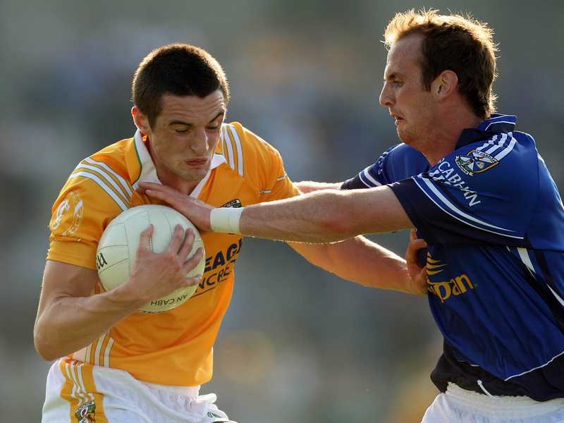 Niall McKeever of Antrim with Ciaran Galligan of Cavan