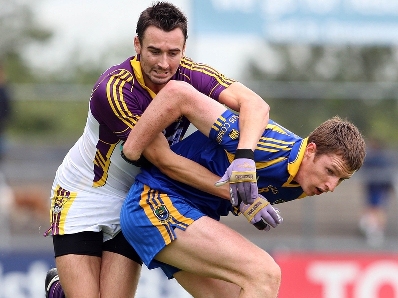 Adrian Morrisey of Wexford tangles with Michael Finneran from Roscommon