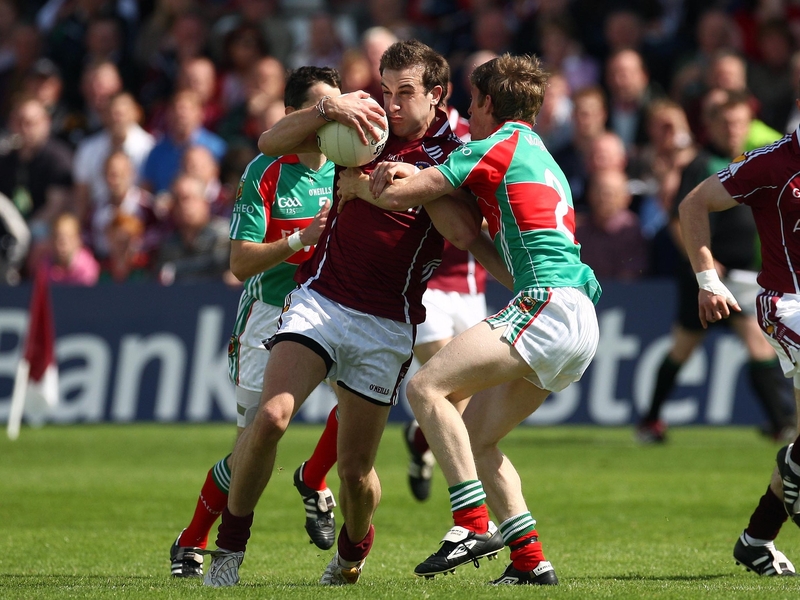 Galway's Nicky Joyce is tackled by Mayo's Liam O'Malley