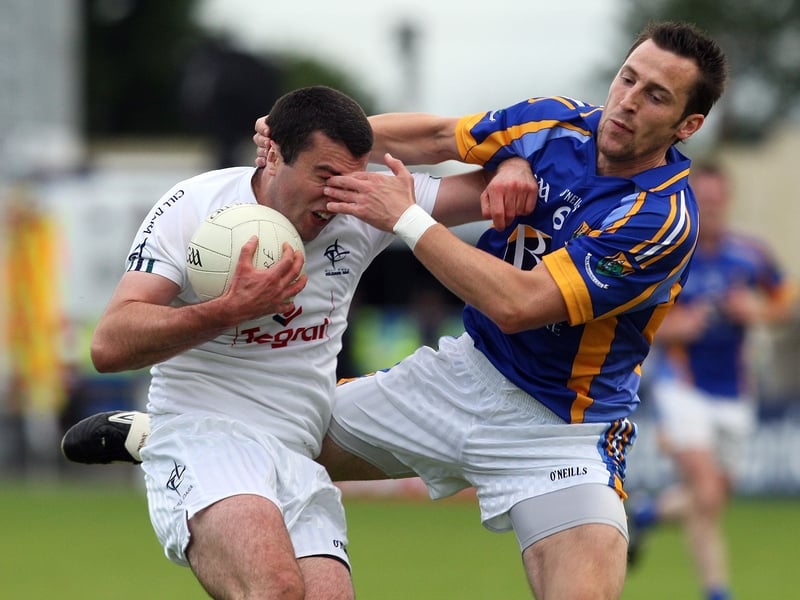 Kildare's Padraig O'Neill tries to break free from the attention of Wicklow's Brian McGrath