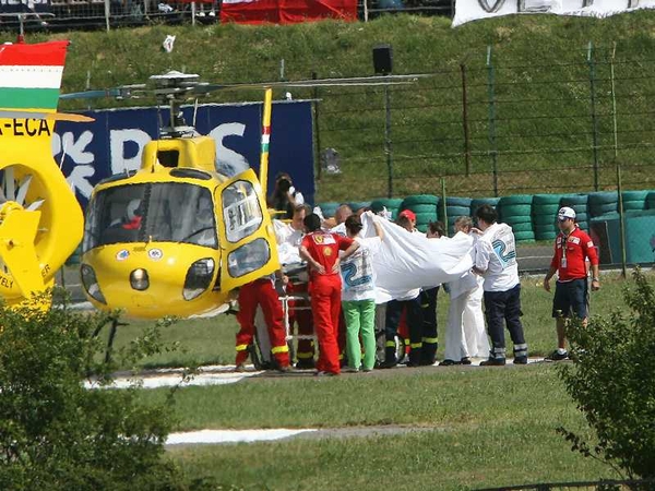 Felipe Massa is brought to a waiting helicopter after Saturday's accident