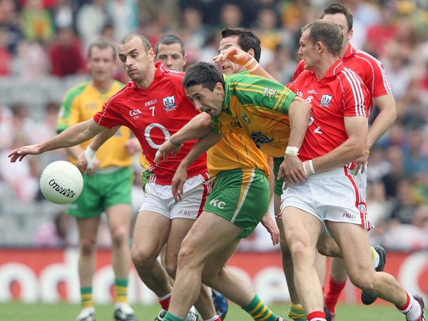Cork's John Miskella and Alan O'Connor compete for possession with Rory Kavanagh of Donegal