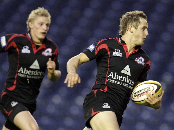 Edinburgh's Mark Robertson sprints past a deserted stand in Murrayfield to record the first try of the match