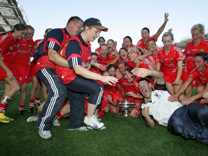 The Cork manager Denise Cronin and her team celebrate after the final whistle in the senior decider