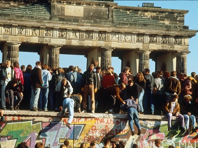 People sit on the Wall to celebrate the end of segregation on 9 November 1989