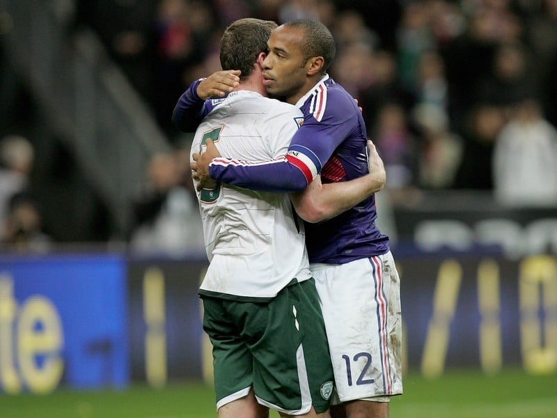 Richard Dunne is embraced by Thierry Henry after Ireland's controversial defeat in Paris