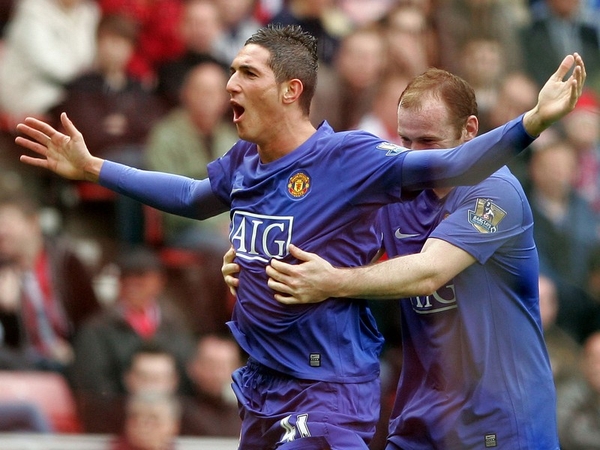 Federico Macheda celebrates with Wayne Rooney after scoring a goal to secure a 2-1 victory over Sunderland last April