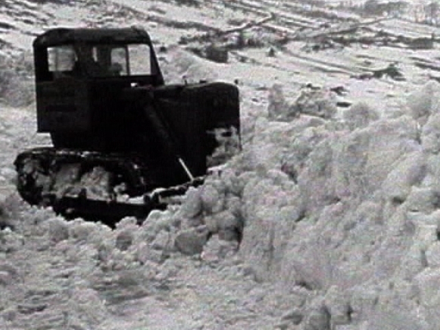 A snow plough battles through the drifts.