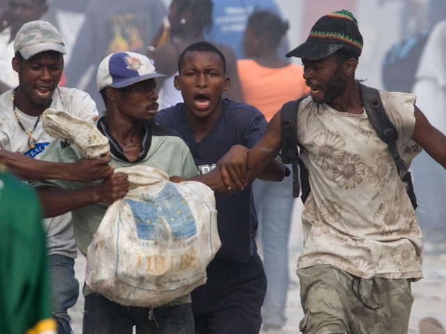 Desperate survivors fight for the little aid that arrives in the capital