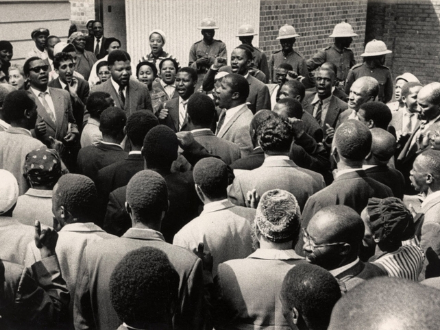 Nelson Mandela and friends sing 'Nikosi Sikelel I Afrika' at the end of the treason trial 29 Mar 1961