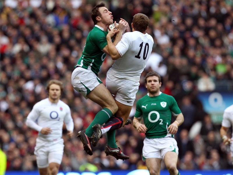 Tommy Bowe and Jonny Wilkinson battle for posession at Twickenham