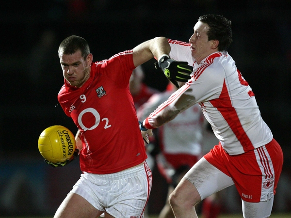 Pearse O'Neill of Cork tangles with Colm Cavanagh of Tyrone
