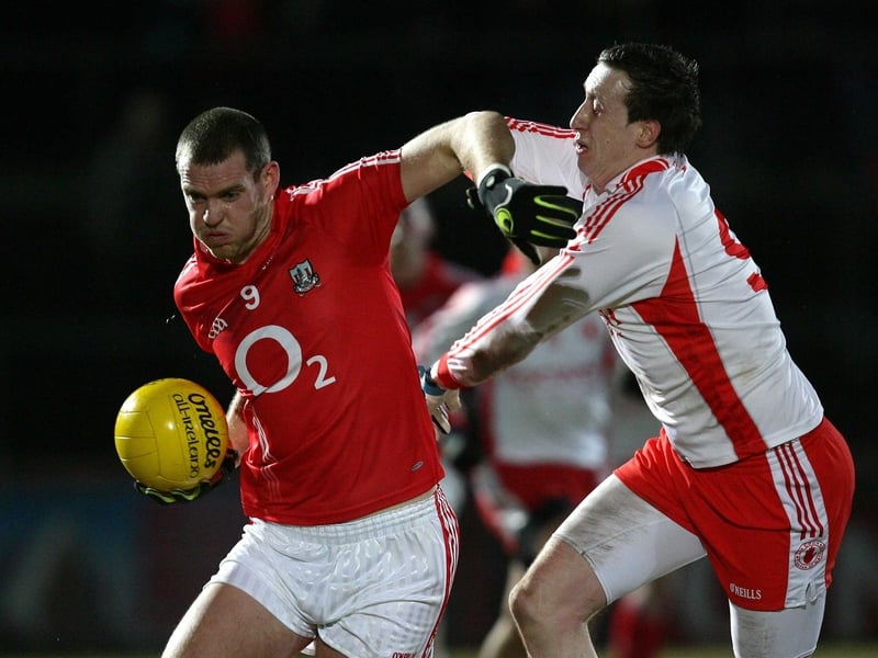 Pearse O'Neill of Cork tangles with Colm Cavanagh of Tyrone