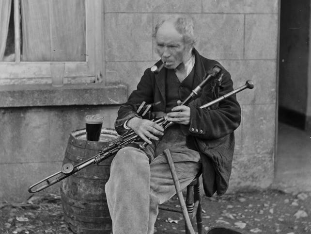 Uileann piper. Location unknown. Lawrence Collection: 1880-1914