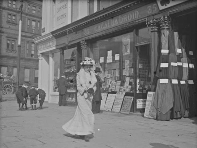 Woman walking past stationery shop, O'Connell Street. View of shop fronts, including Catal Broin and John Averill. Clarke Collection: 1890-1910