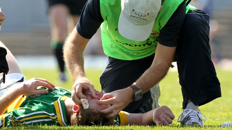 Cooper receives medical treatment on the field after sustaining the injury to his eye against Monaghan