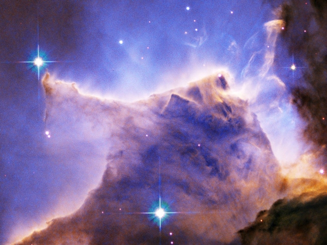 A detail of the Eagle Nebula (M16) showing a portion of a pillar of gas and dust. Light from nearby hot young stars is sculpting the cloud