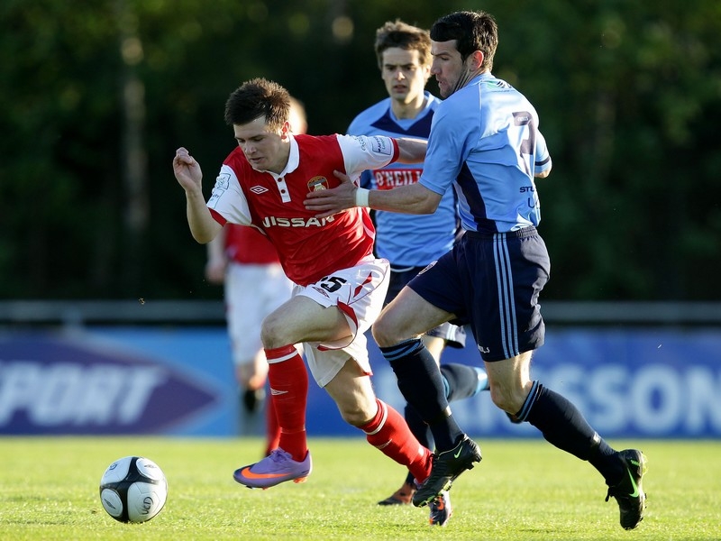Brian Shortall of UCD looks to stop St Pat's man Gareth Coughlan