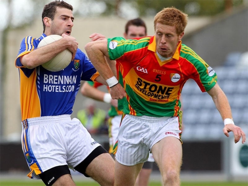 Tony Hannon of Wicklow is tracked by Carlow's Alan Curran
