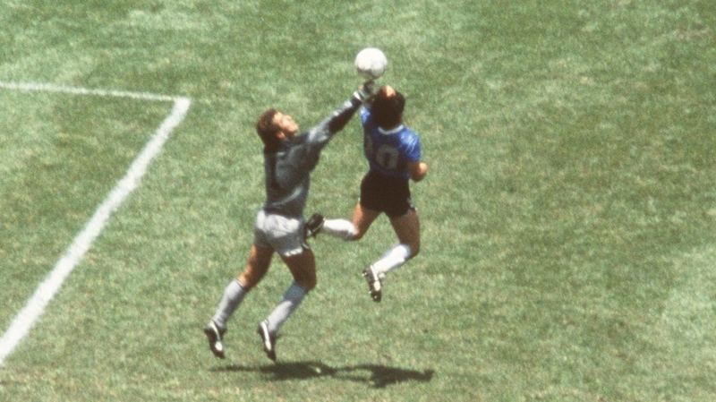 Maradona and his arm rise above Peter Shilton