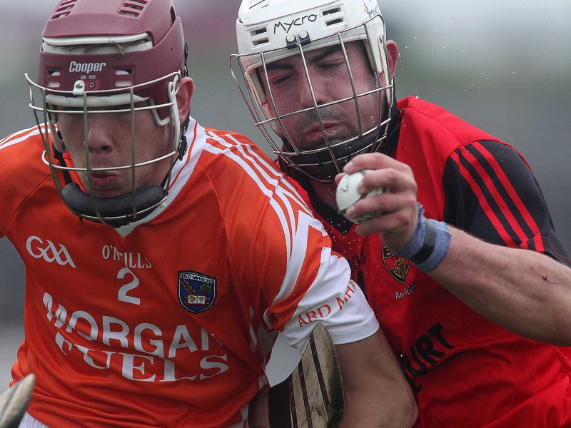 Donal Carvill of Armagh tussles with Down's double goalscorer Johnny McClusker